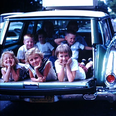 Kids pose in the back of a station wagon 1958.
