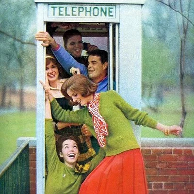 1962 fashion photo showing popular "how many can fit in a phone booth" gag.