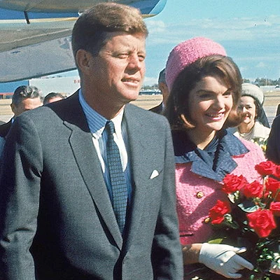 President Kennedy is assassinated on November 22, 1963 while travelling in a motorcade through downtown Dallas, Texas. His assassin, Lee Harvey Oswald, is quickly caught, but is shot to death himself a few days later.