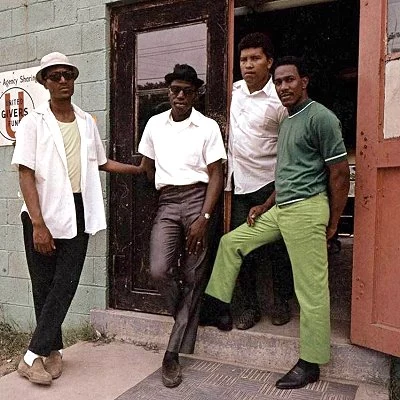Four men hanging out in Harlem, New York City.