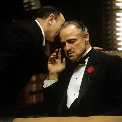 The Godfather is a film adaptation of Mario Puzo's novel starring Marlon
Brando, Al Pacino, Robert Duvall, James Caan and Diane Keaton. The first in a series of three, the film wins Academy Awards for Best Picture, Best Actor (Brando) and Best Screenplay.