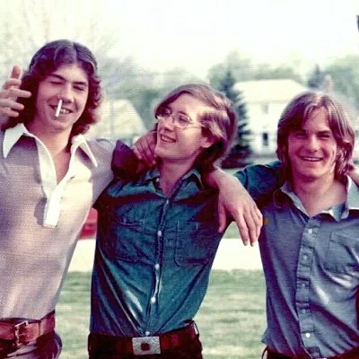 A trio of high school boys captured clowning around with a cigarette.