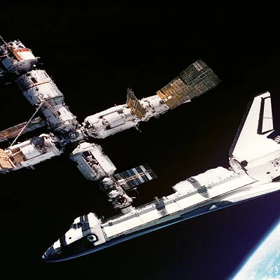 The U.S. space shuttle Atlantis docks with the Russian space station Mir.